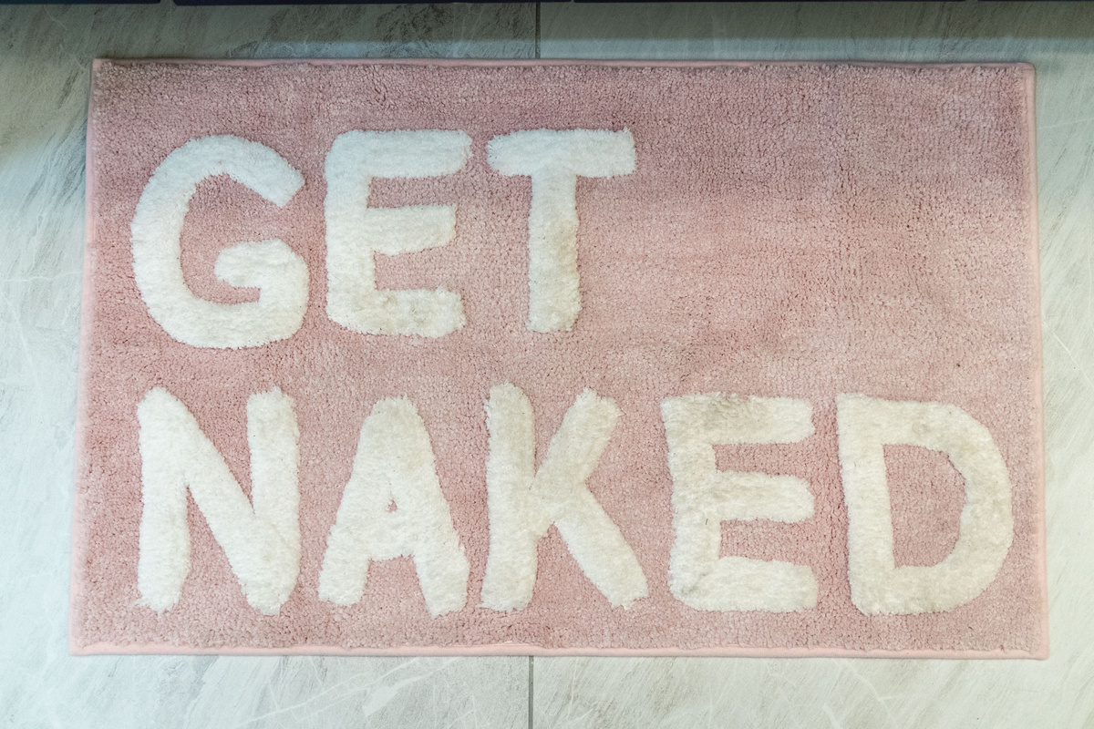 A playful bath mat adds personality to the stylish, spa-inspired bathroom.