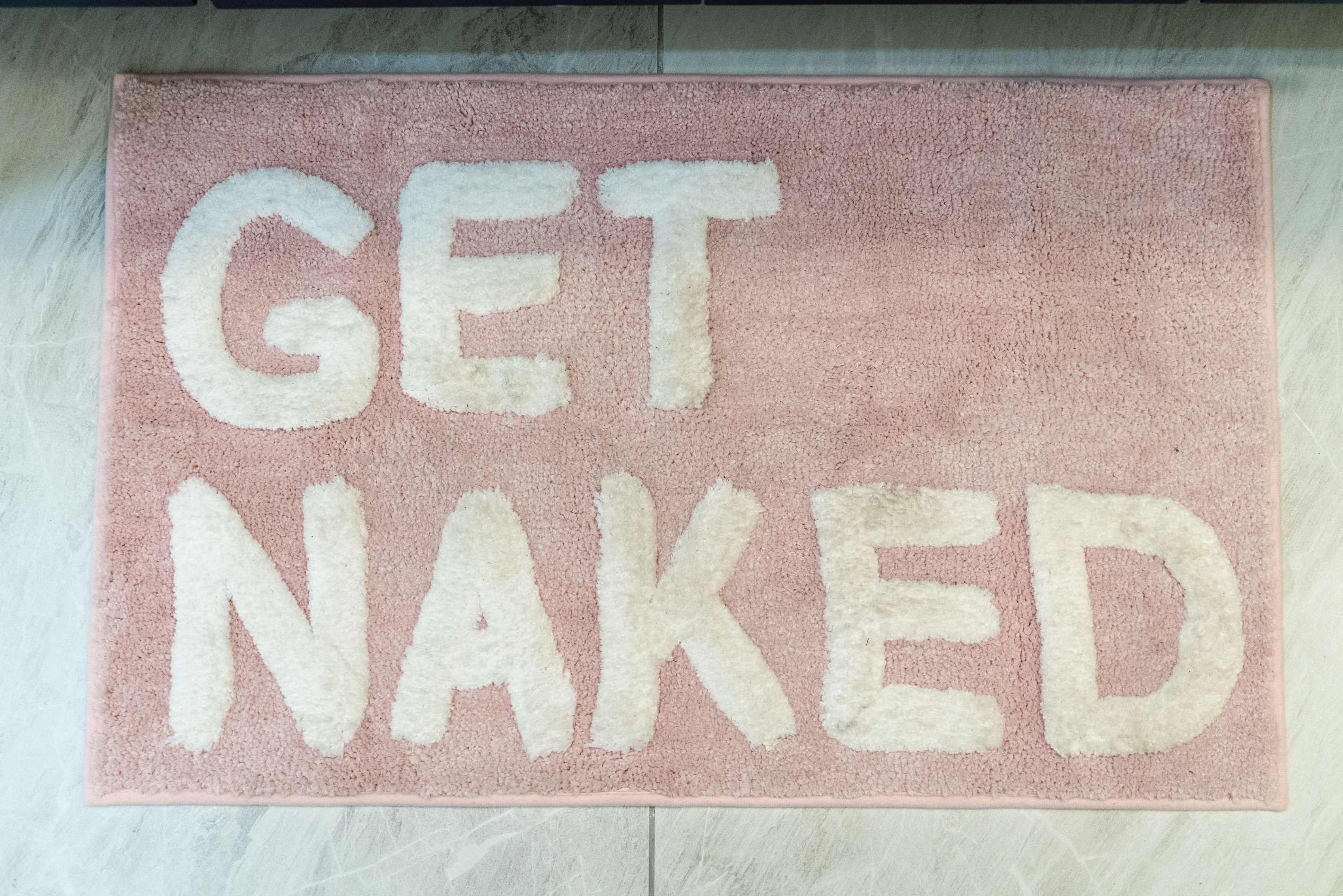 A playful bath mat adds personality to the stylish, spa-inspired bathroom.