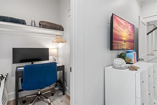 Dedicated Workspace - Tucked off the first-floor king suite, this private workspace features a small window, door, desk, comfortable chair, large monitor, docking station, keyboard, and a mouse—ideal for remote work while enjoying your beach getaway.