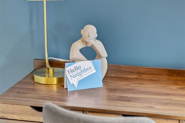 Stay productive with a dedicated desk setup featuring modern artwork, a gold lamp, and high-speed Wi-Fi. Ideal for remote work, study, or creative projects, this workspace ensures comfort and focus during your Des Moines stay.