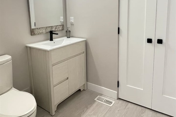 Main level Bathroom. Attached is the door to the laundry room where you can find washer, dryer, ironing board and light cleaning supplies.