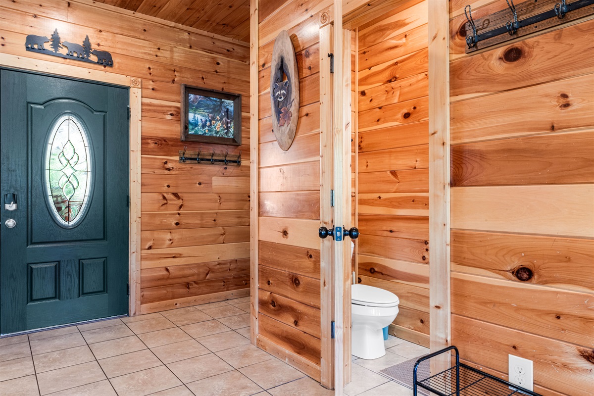 Half bath conveniently located off the kitchen. Plenty of wall hooks for hanging coats, purses, and keys.