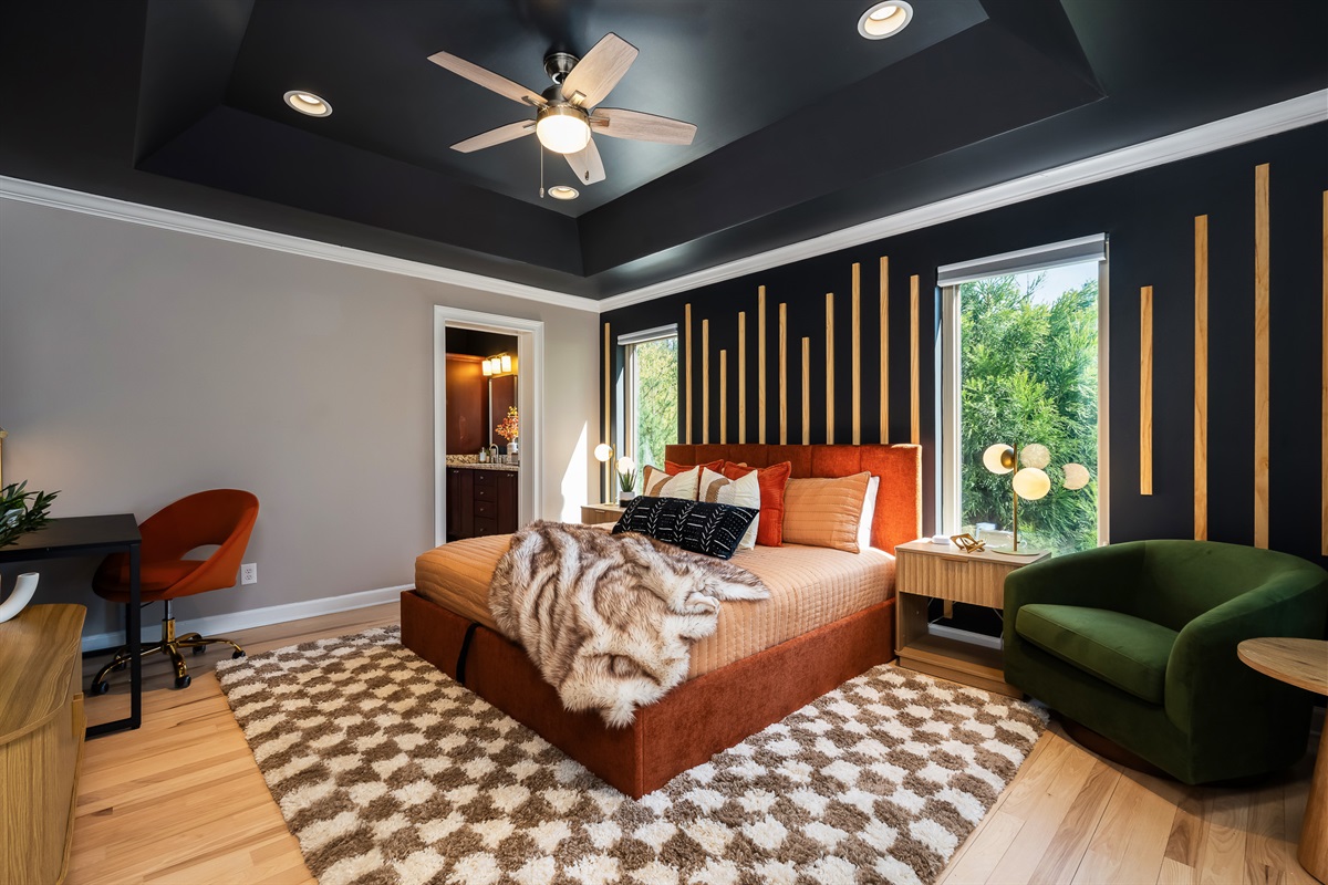 Primary-style bedroom with custom wall detail and natural light - elevated design throughout