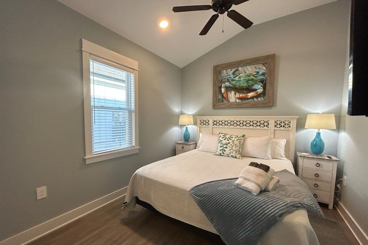 King bedroom is well decorated and has cathedral ceilings.