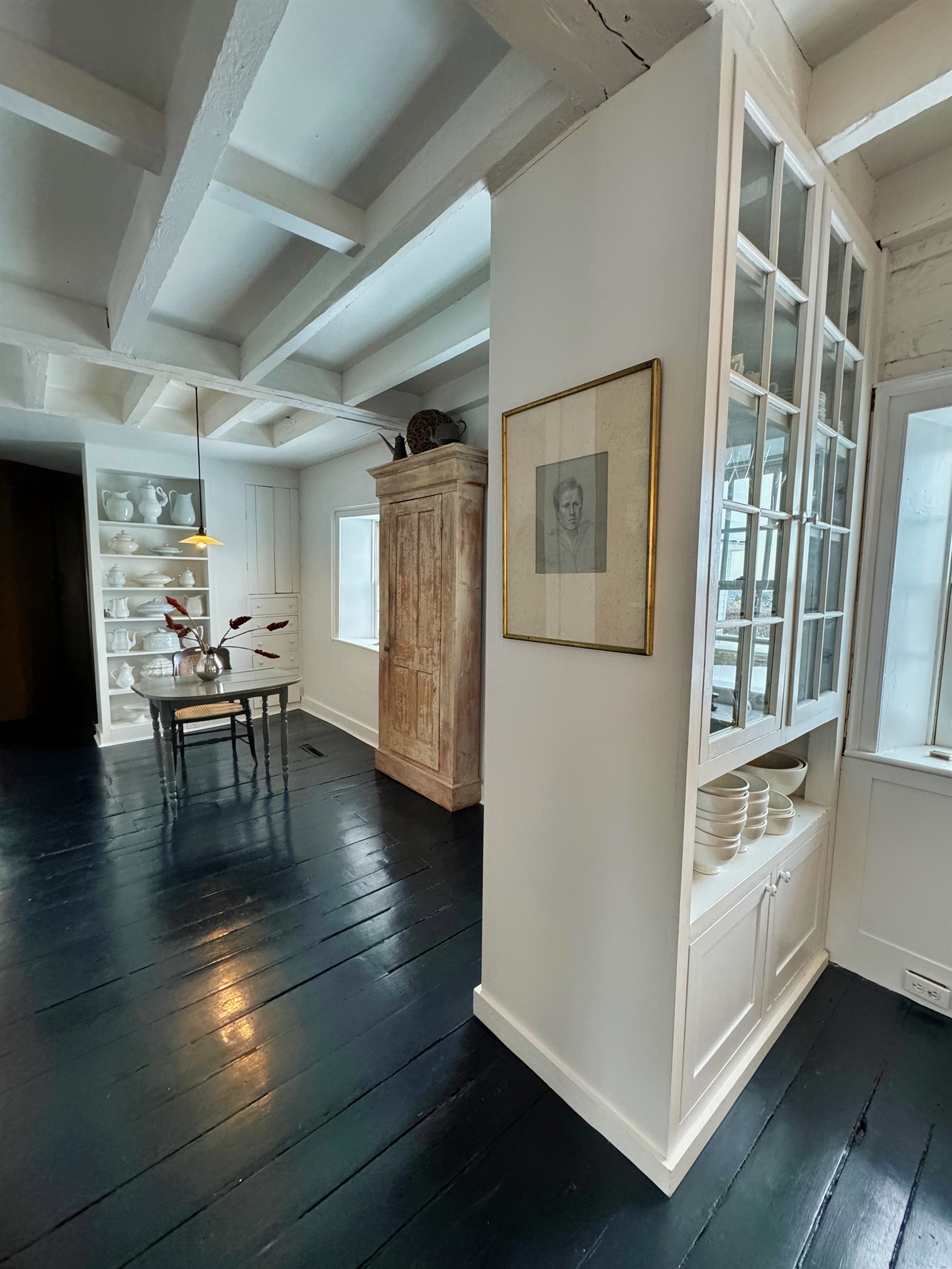 Hawk Field House - Entryway into the main part of the house, with seating, a pantry and dish storage.