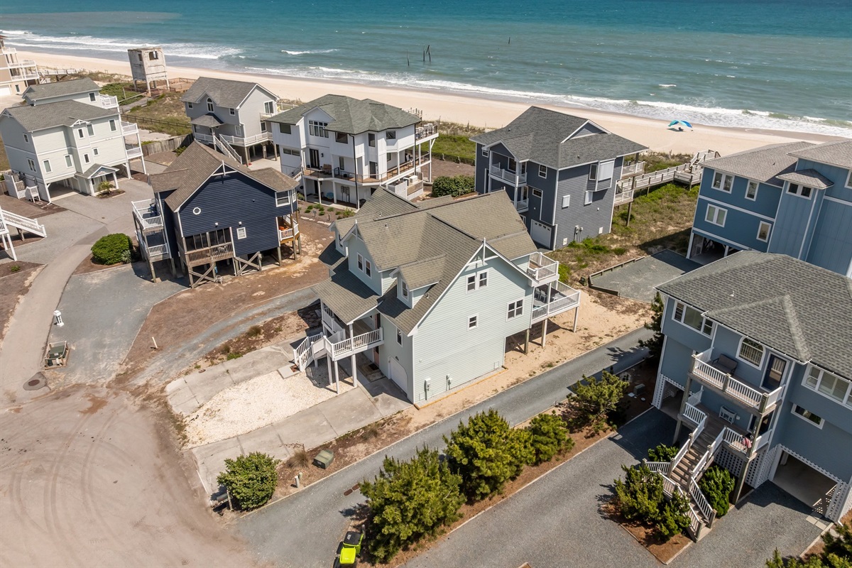 Oceanfront properties, a mix of colors and sizes, create a vibrant seaside community.