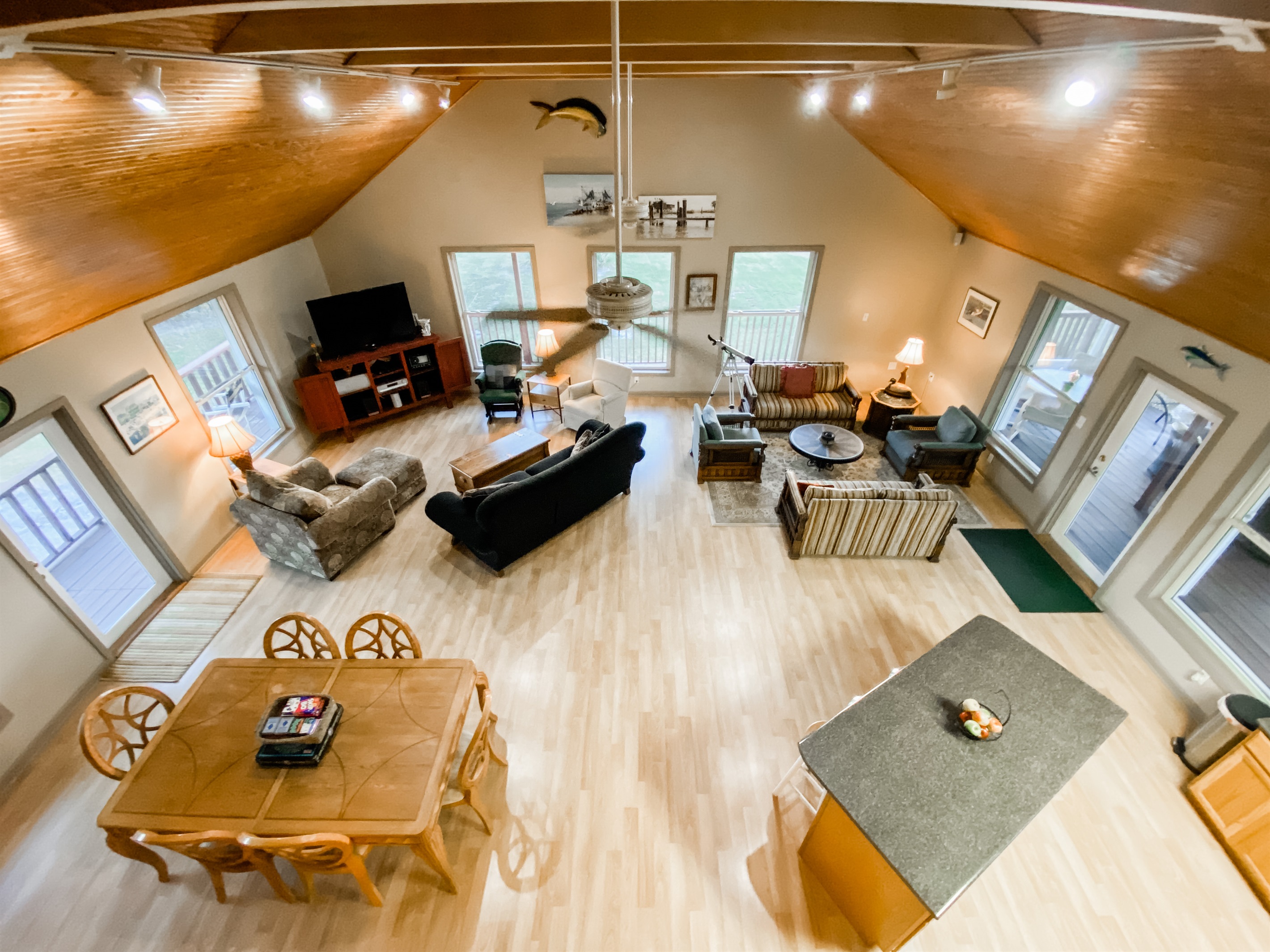 TOpen concept gathering and cooking area surrounding by large windows from all sides.