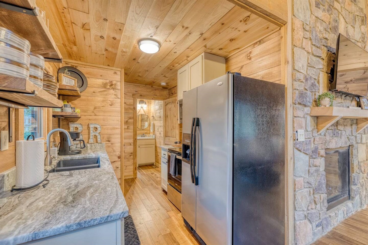 Step into our kitchen area, where every inch is maximized for efficiency and every detail exudes cozy charm, creating a delightful space for culinary adventures.