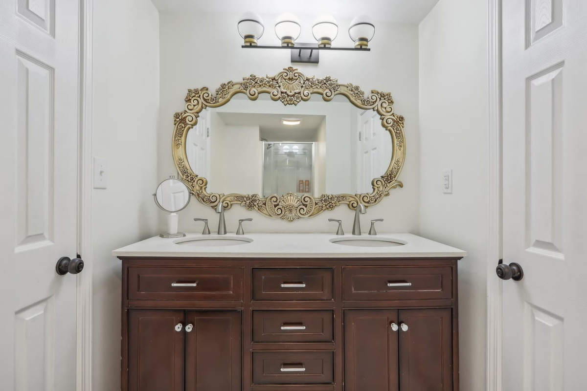 Get ready with ease in full bathroom 3, featuring a double vanity, elegant mirror, and plenty of storage for your essentials.