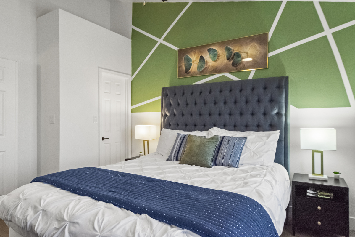 Relaxing bedroom with two bedside tables, a huge window for natural light, and a hybrid mattress for added comfort. 