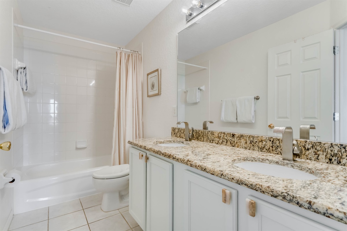The shared bath on the second floor has double sinks for convenience.
