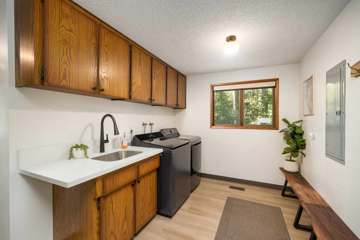 Original wood cabinetry gives this laundry nook real cabin character.