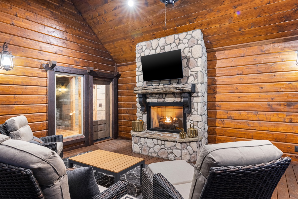 Outdoor lounge with stone fireplace for cozy evenings in the mountains