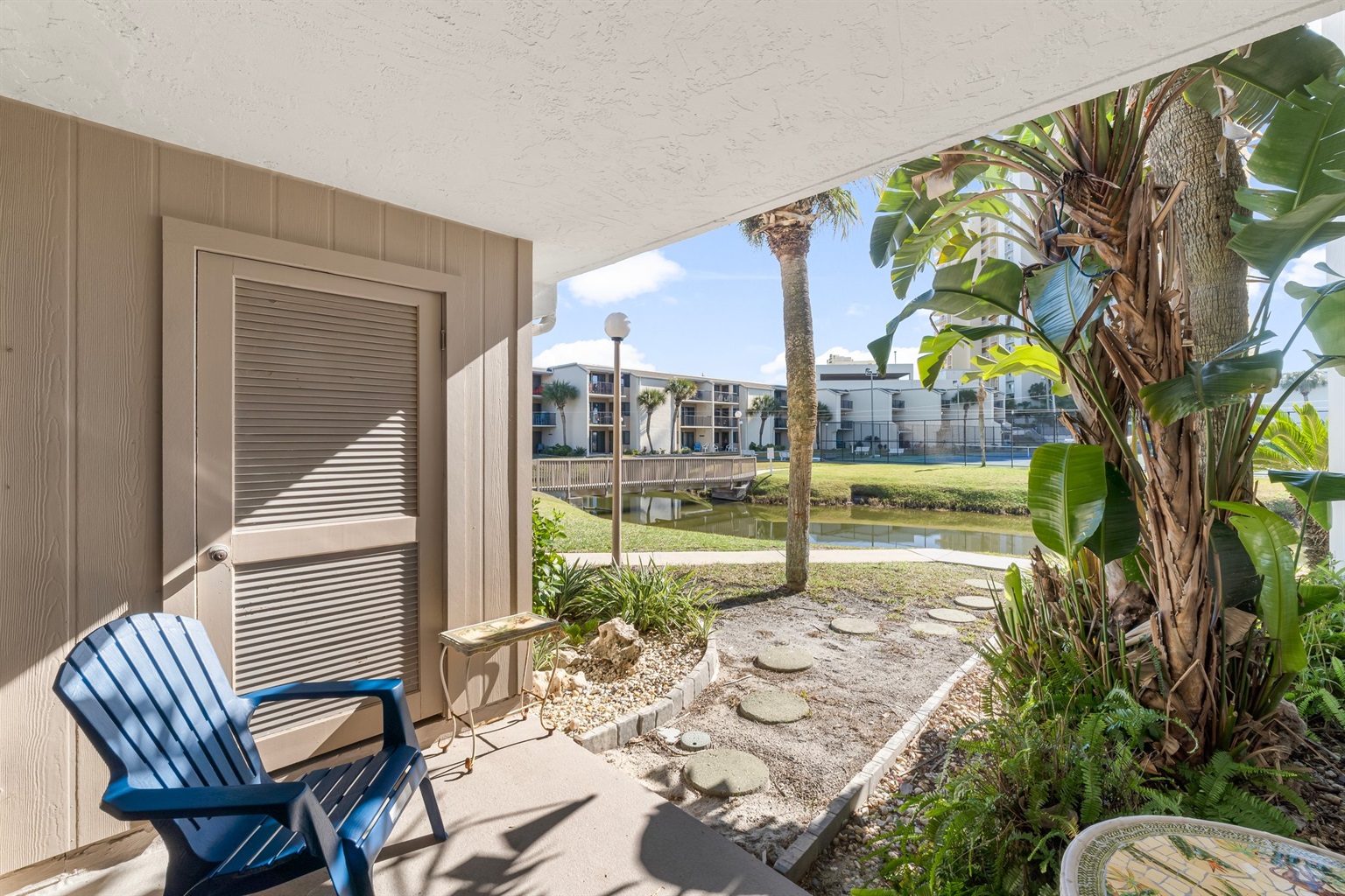 Patio Retreat: Sip your morning coffee with stunning views of lush greenery and serene waters!