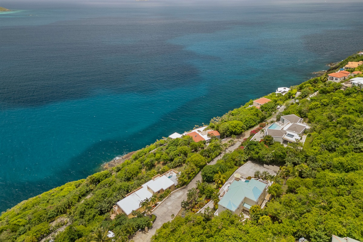 Charming island villa exterior with tropical plants and free parking. A beautiful welcome, every time.