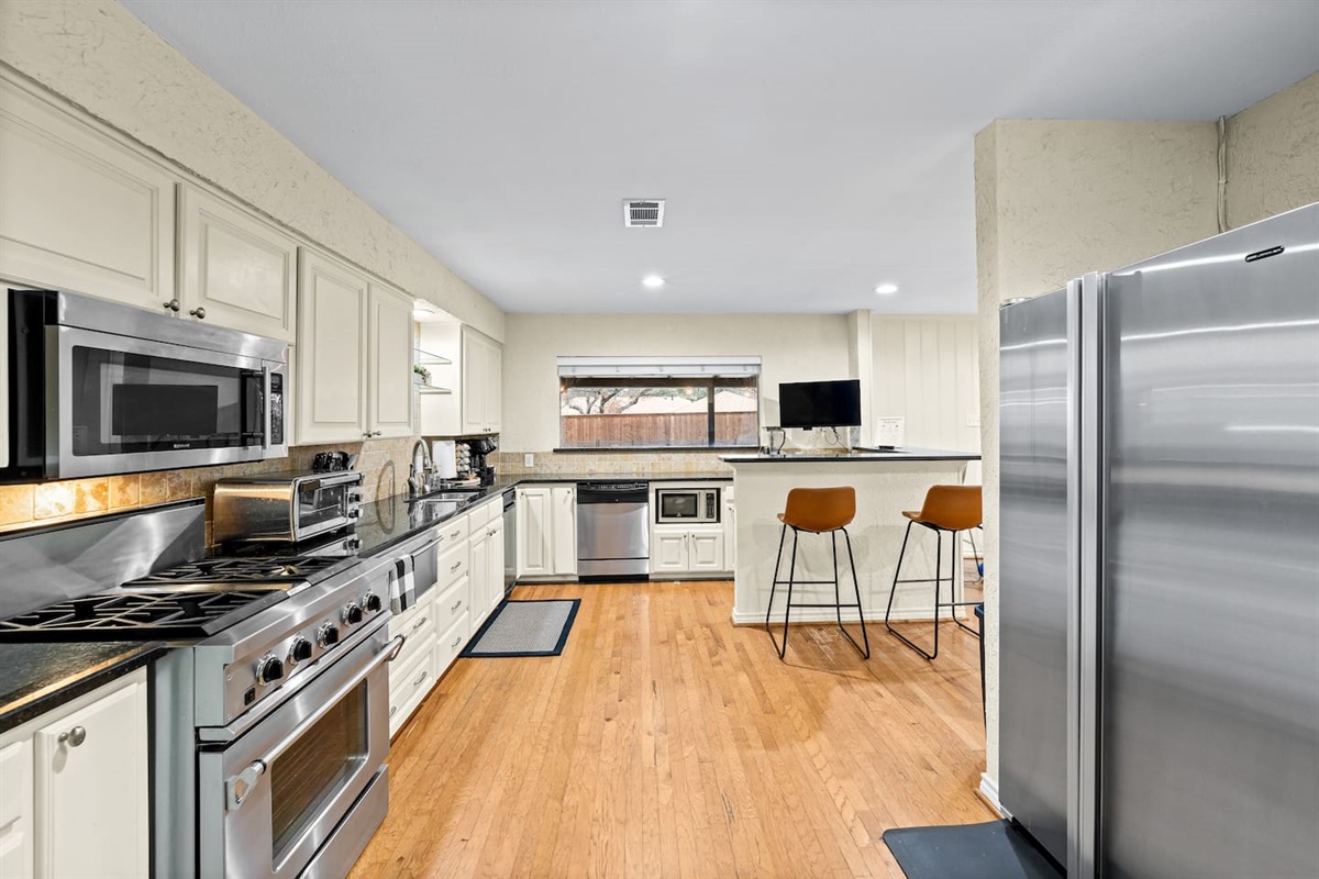 Bright, open kitchen with modern appliances and clean lines—perfect for cooking, entertaining, and staying connected to the group.