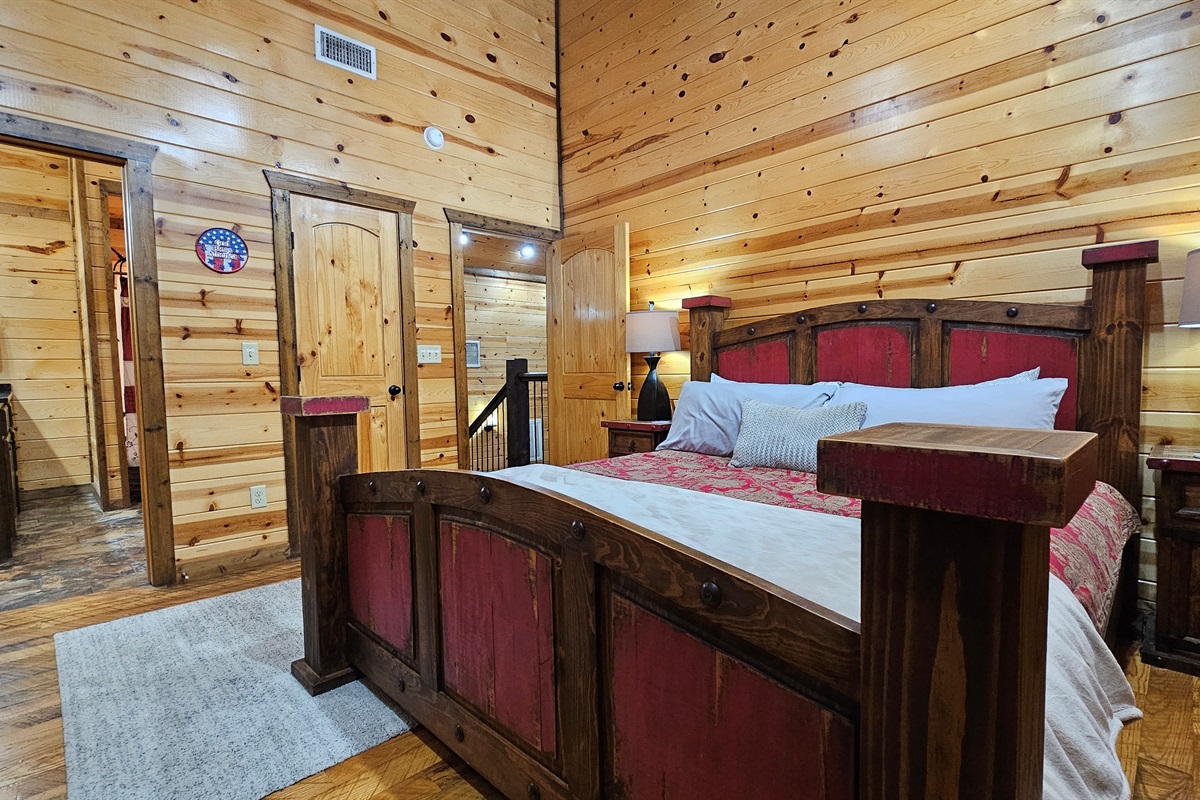 Bedroom 3: Rustic charm meets modern comfort with stunning wood accents and a serene view!