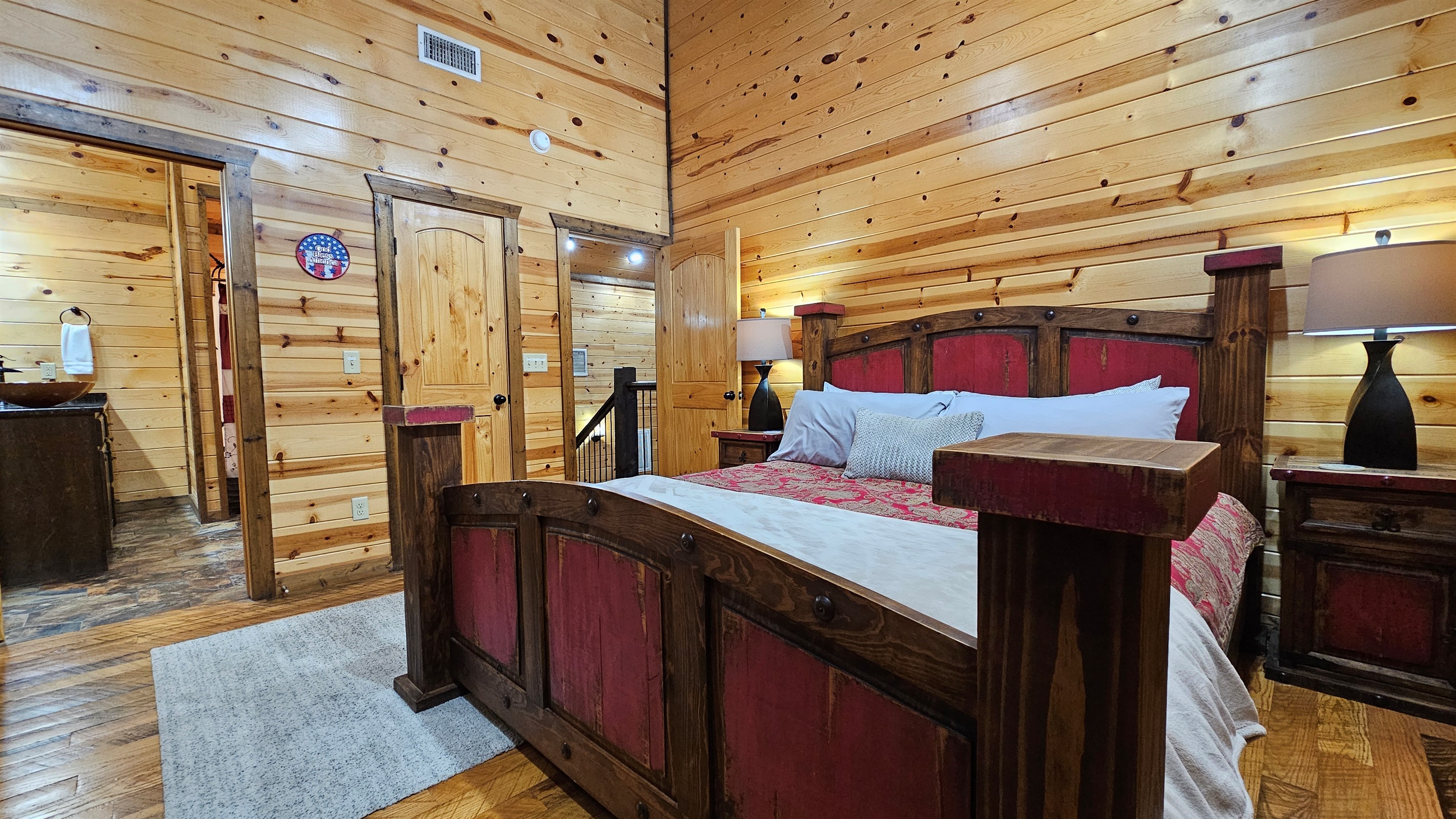 Bedroom 3: Rustic charm meets modern comfort with stunning wood accents and a serene view!