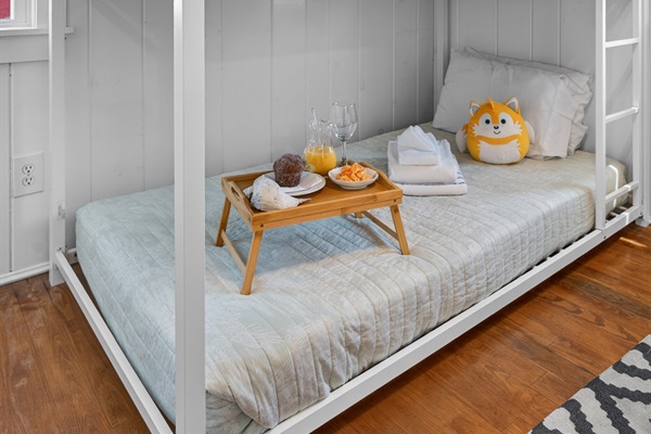 Cozy secondary sleeping space featuring twin bunk beds and efficient layout.