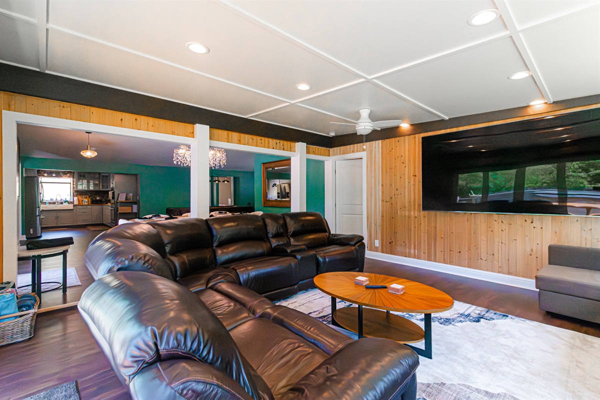 Designed for both relaxation and entertainment, the living room features stunning waterfront vistas and an impressive large-screen TV for the ultimate viewing experience.