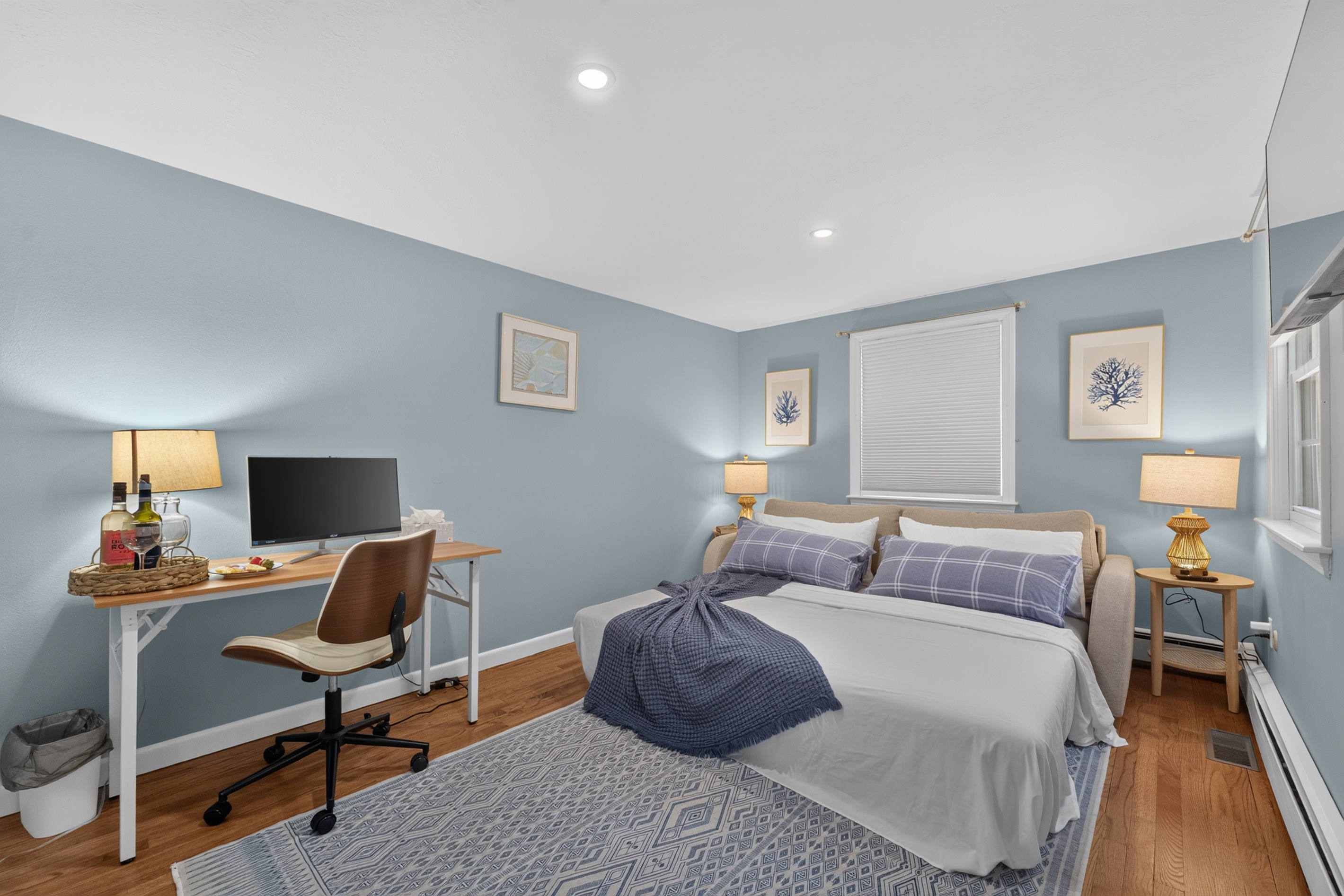 A relaxing retreat with cozy bedding and a functional workspace.