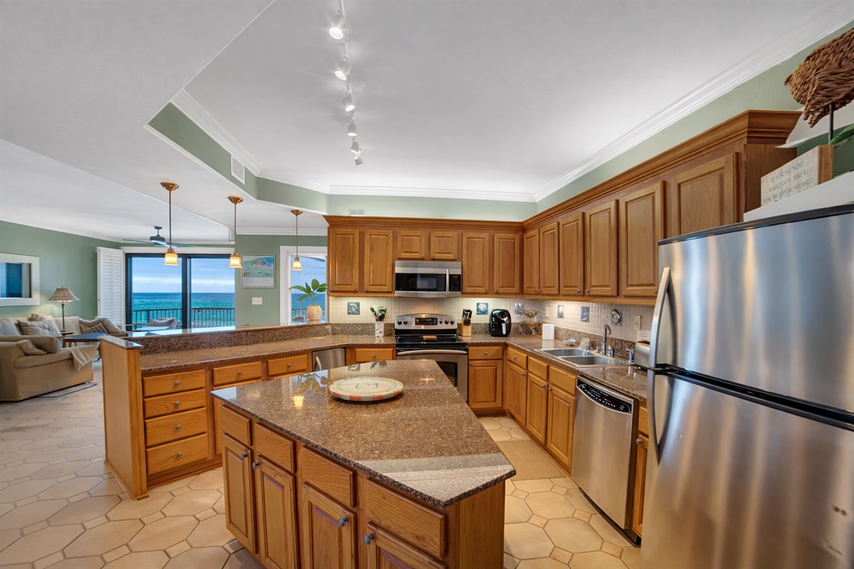 Kitchen with stainless steel appliances, quartz tops, tiled backsplash and Gulf view 