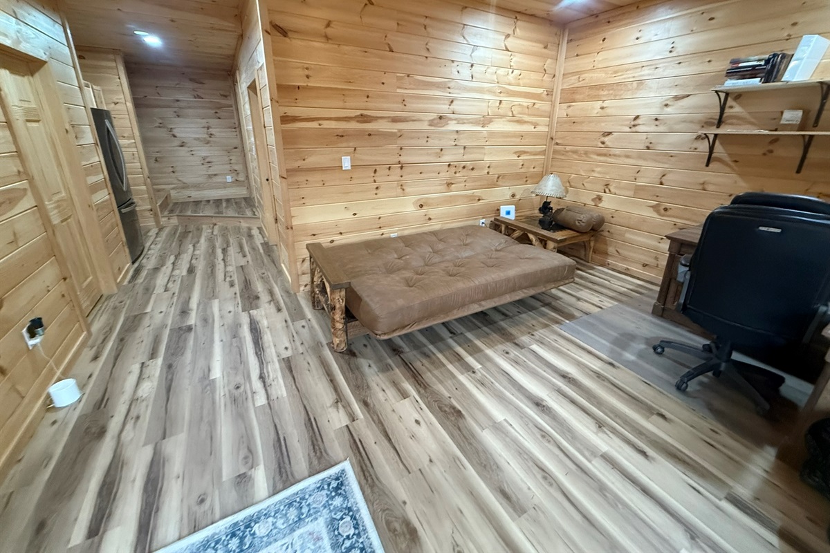bedroom 2 in small cabin over garage. Linens, pillows, comforter are provided for sofa bed.