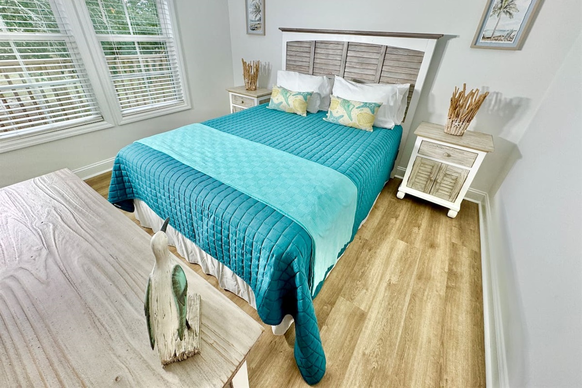 Queen bed with a smart TV and blackout curtains.