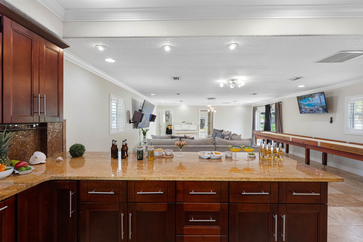 The combination of ample storage, a large prep island, and contemporary lighting makes this kitchen as practical as it is beautiful.