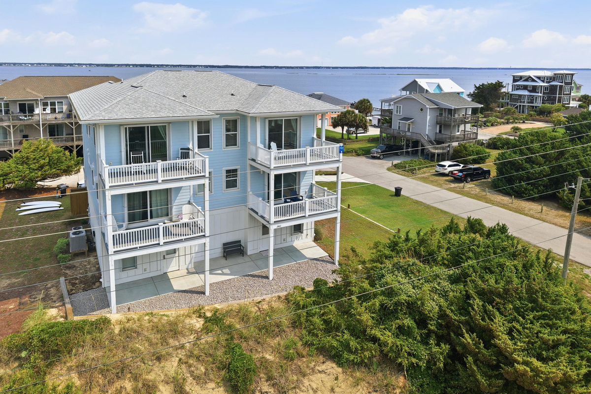 Aerial view showcasing the home&rsquo;s prime coastal location, multiple decks, and proximity to the water