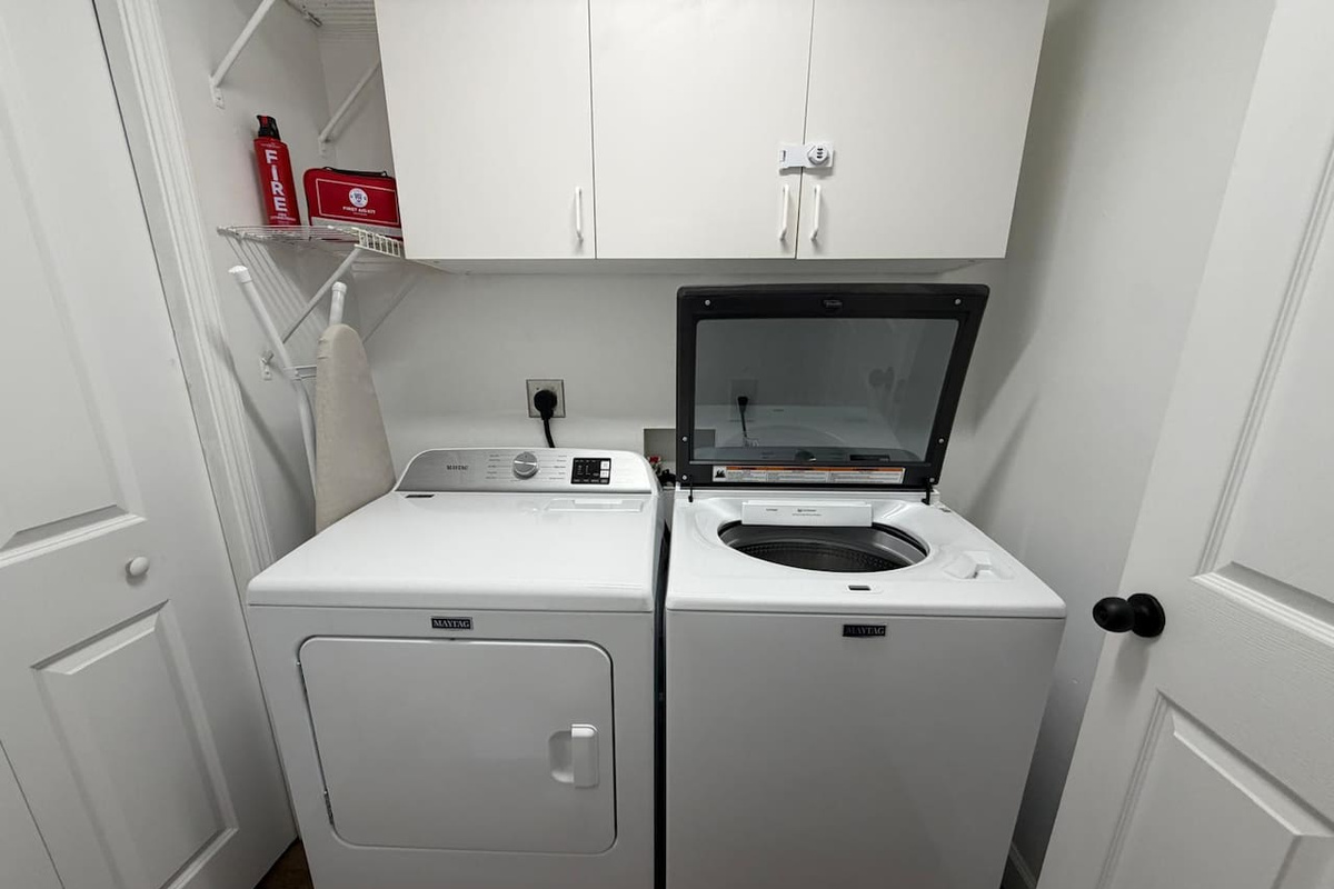 The laundry area features a full sized washer and dryer and an iron and ironing board.  A complimentary initial supply of laundry detergent is provided.  The fire extinguisher and first aid kit can be found in the laundry room.