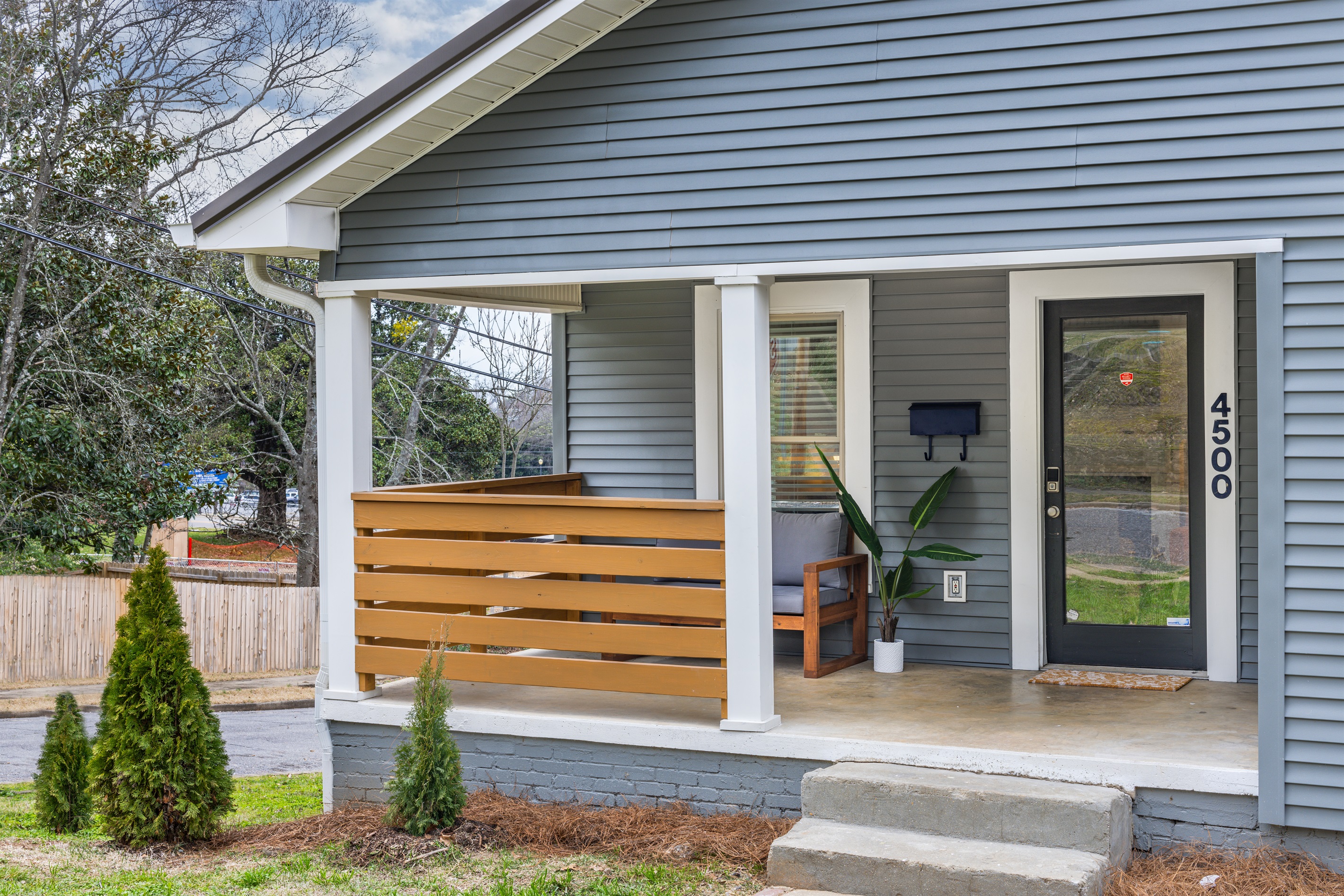 Step up to your charming retreat: The home's front boasts a beautiful, welcoming entrance to begin your stay. *please note this is a triplex*
