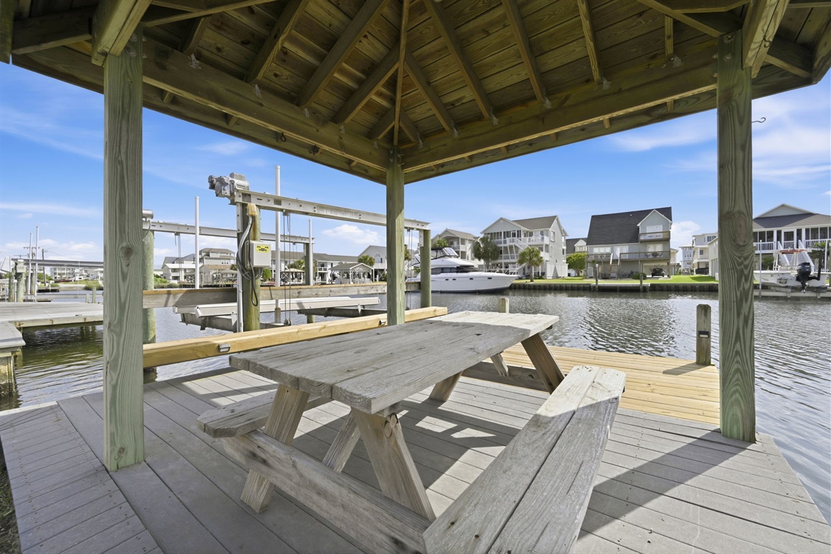 Waterfront gazebo with picnic seating &mdash; perfect for relaxing, dining, or watching the boats go by