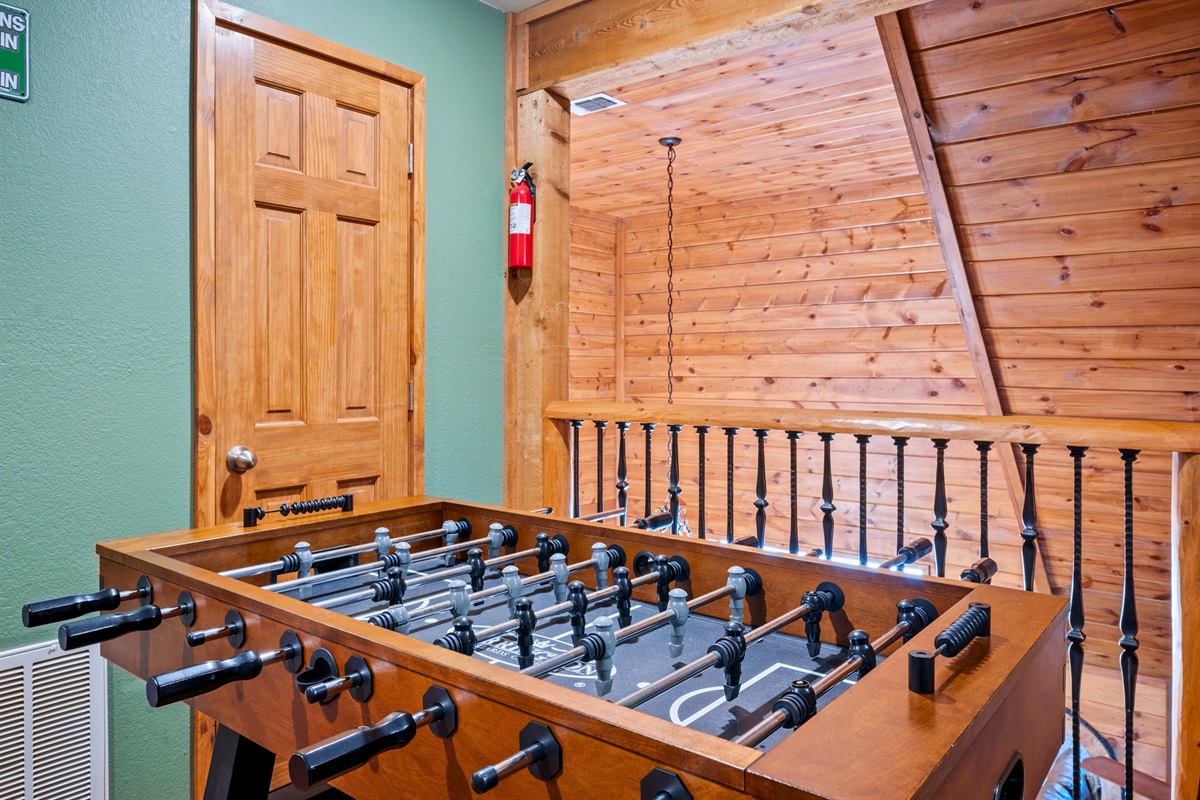 The game loft includes a full-size foosball table for friendly competition.