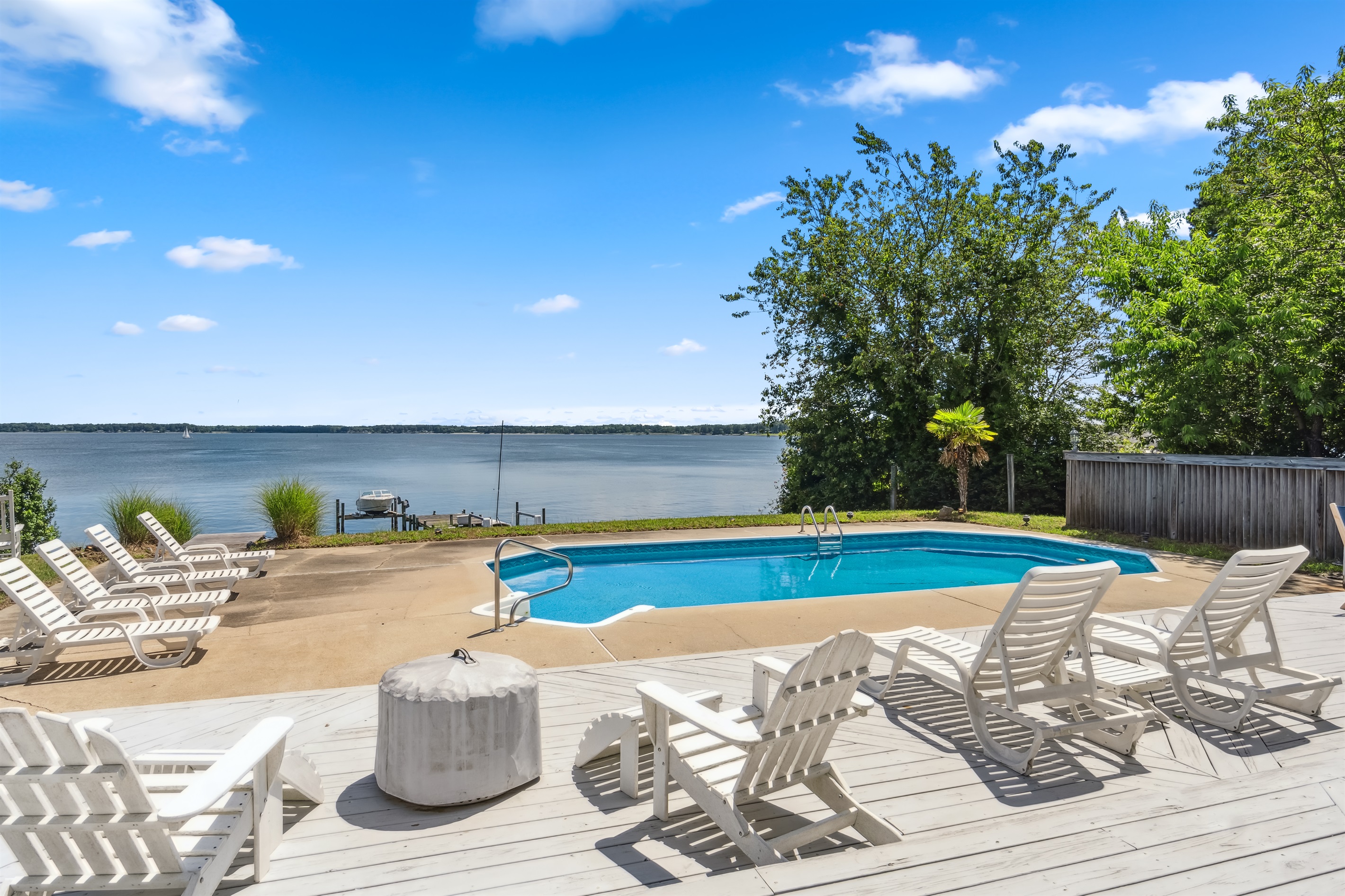 Private waterfront pool with open views and comfy loungers—ideal for swimming and unwinding.