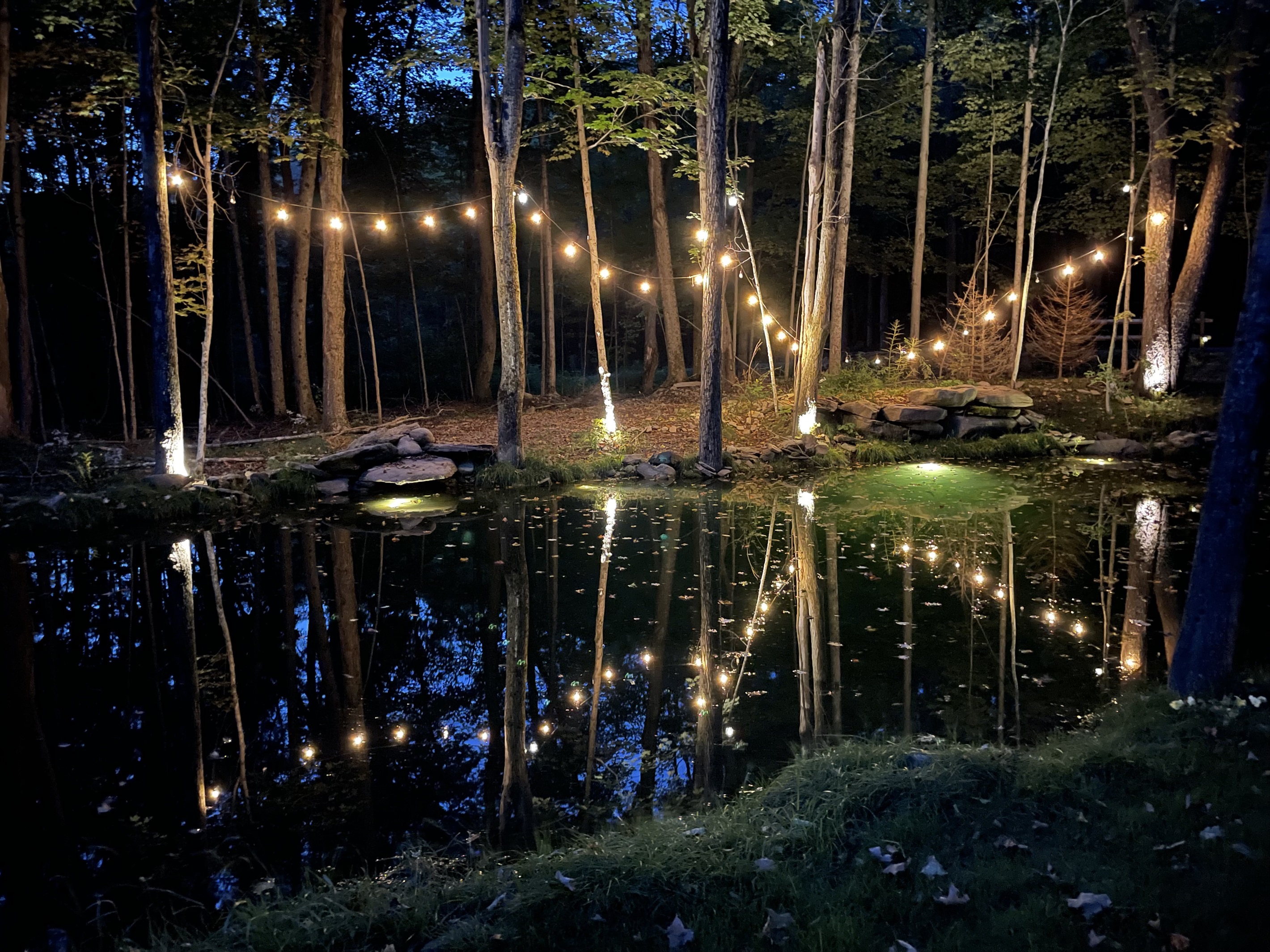 Twinkle lights around the pond, firepits, and hotub areas add to the magic at night!