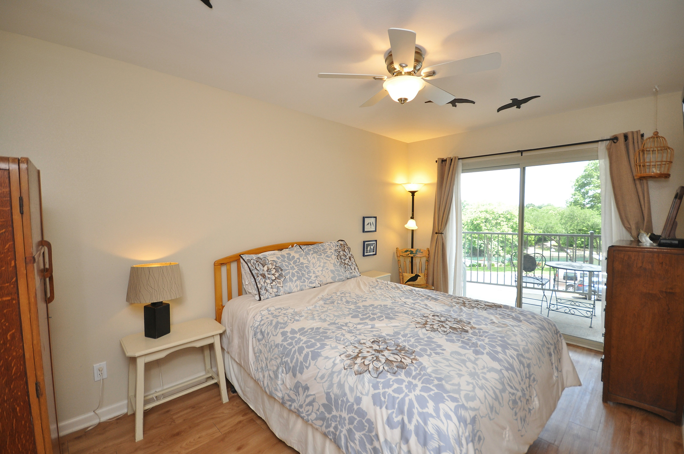 Primary bedroom with door leading to balcony.
