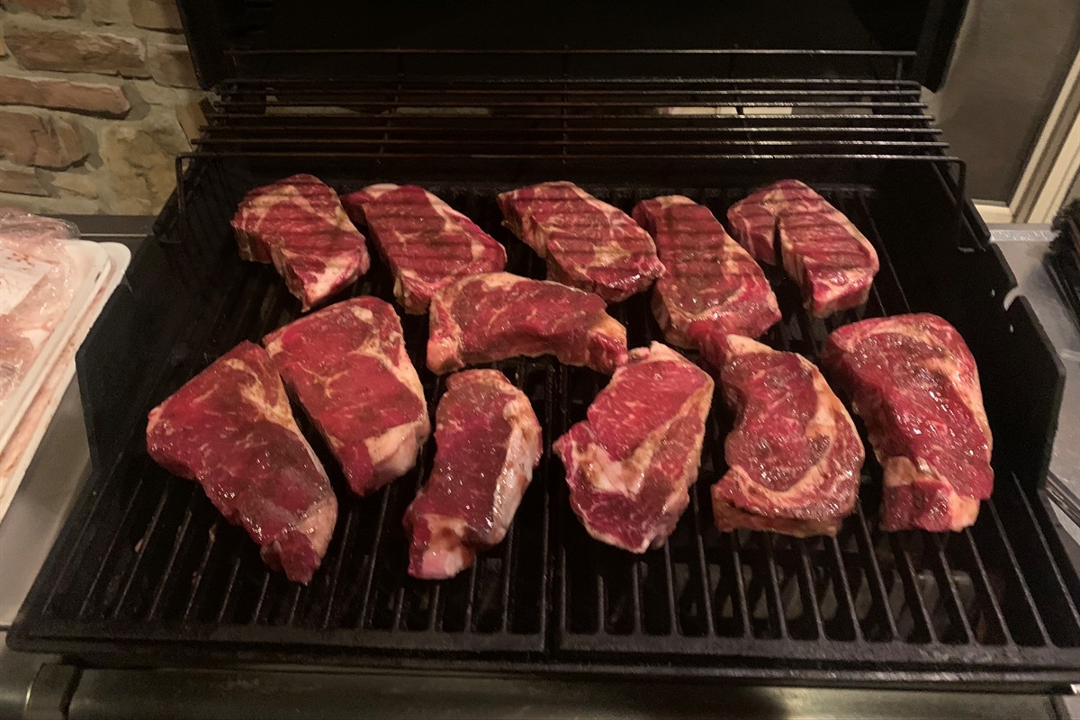 Grilling steaks on the back covered deck.