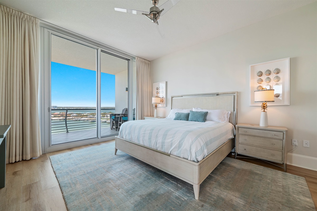 Experience the ultimate in comfort and style in this elegant primary bedroom. Featuring a king-size bed, crisp white beddings, plush furnishings, and breathtaking views, this space offers a peaceful sanctuary for relaxation.