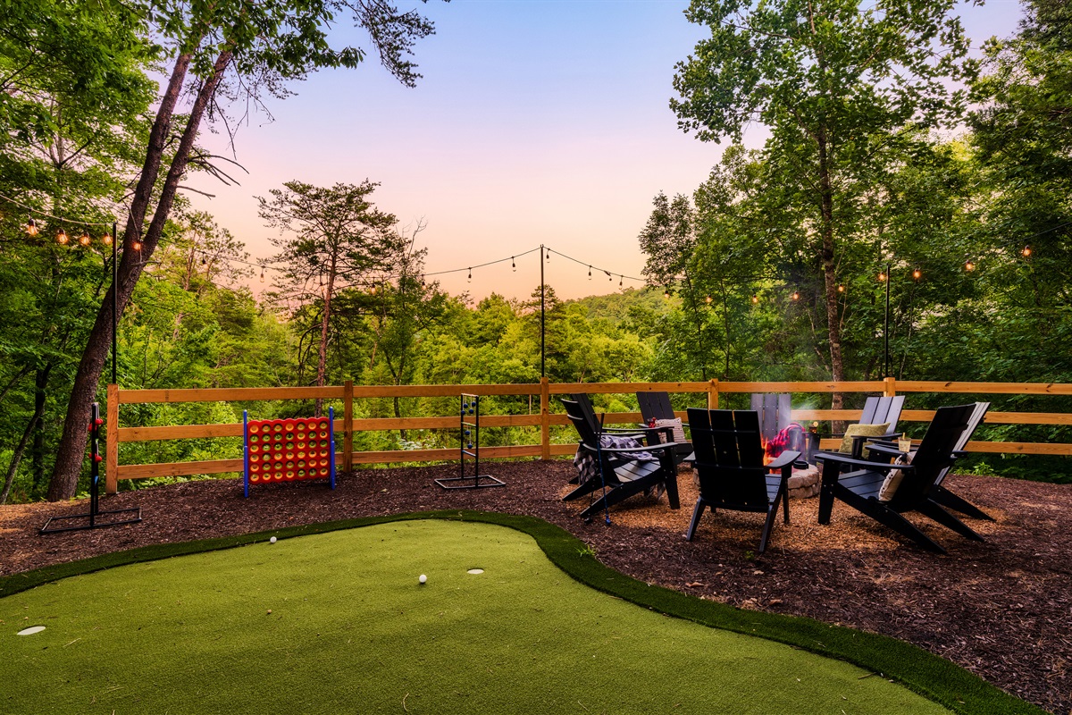 Backyard with fire pit, mini golf, string lights  and games