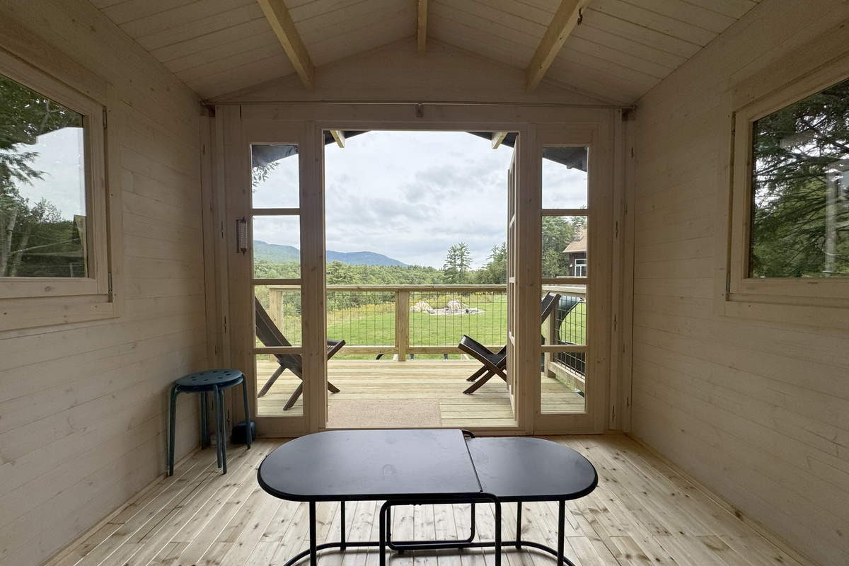 Step from the sitting area onto the deck and take in the beautiful lawn, forest, and distant mountain views.