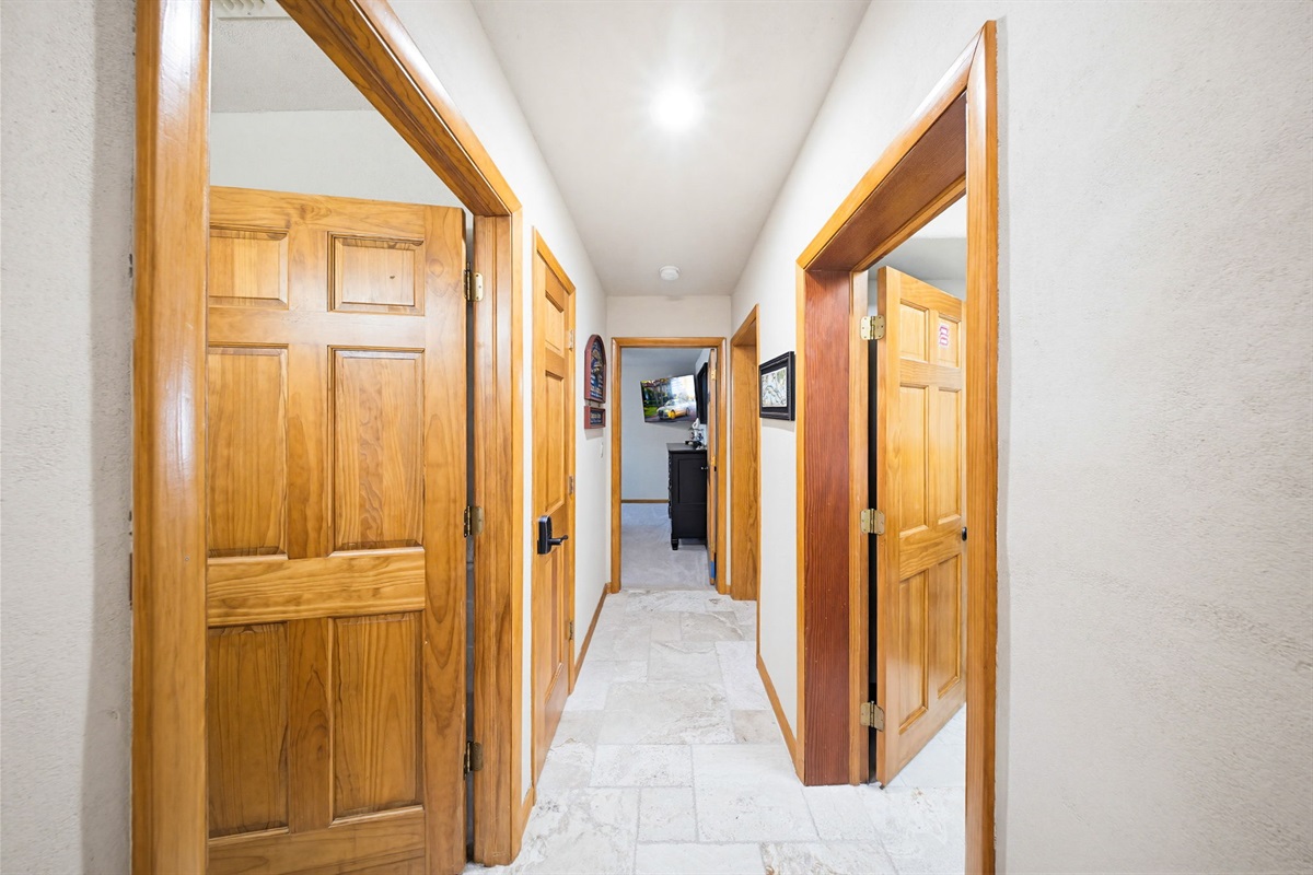 This hall gives access to the second bathroom, the laundry room, and two more bedrooms.