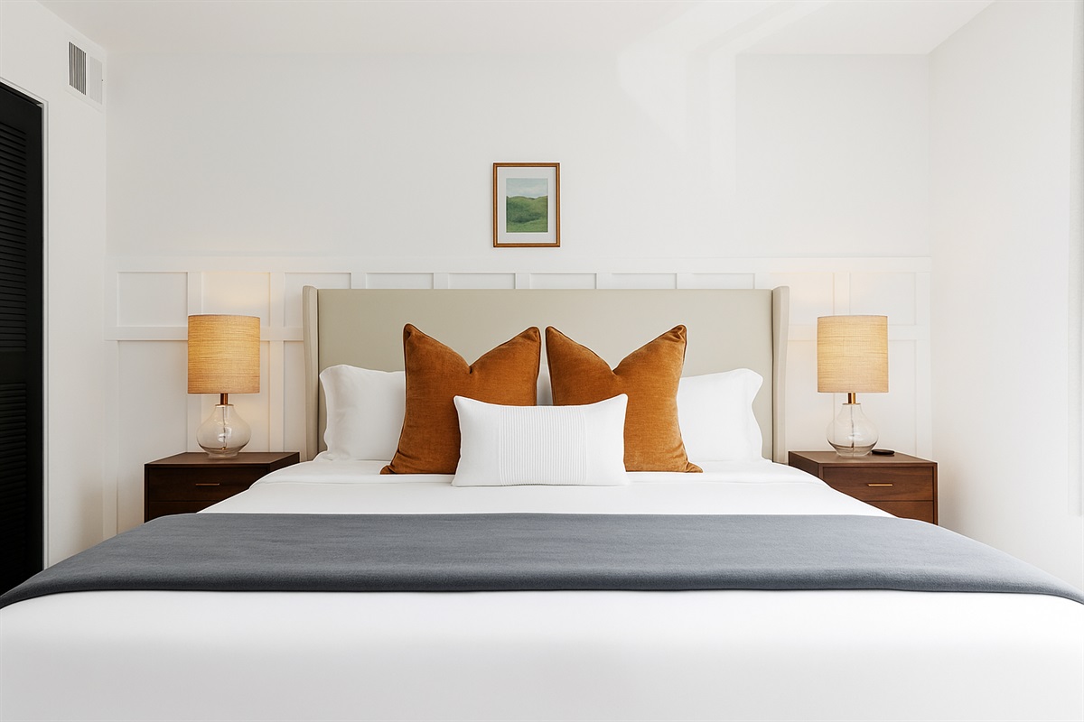 Rest easy in this peaceful bedroom with a king-size bed, soft lighting, and a striking wood accent wall.