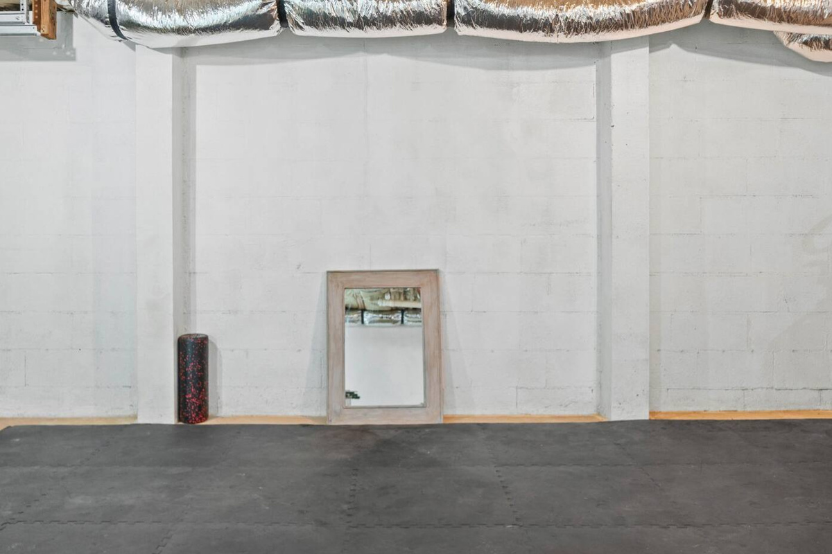 Large area in unfinished basement with foam mats