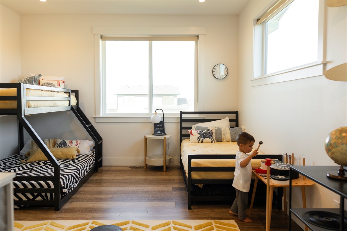{Bunk Room} Upstairs kids’ room featuring a twin-over-full bunk, twin with trundle, TV, and plenty of toys — sleeps 4–5 kids comfortably.