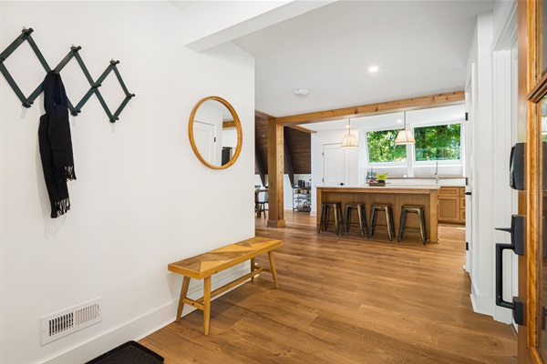 Come in, kick off your shoes and make yourself at home! The foyer is wide and with cute bench, a mirror and a vintage accordion peg rack for easy access to handbags, scarves and hats!