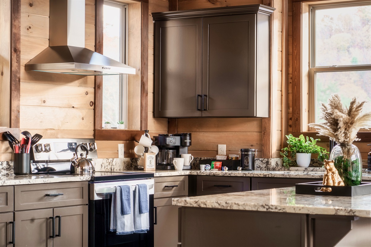 Fully stocked kitchen with pots, pans, rice cooker, blender, toaster, drip, and Keurig and drip coffee machine