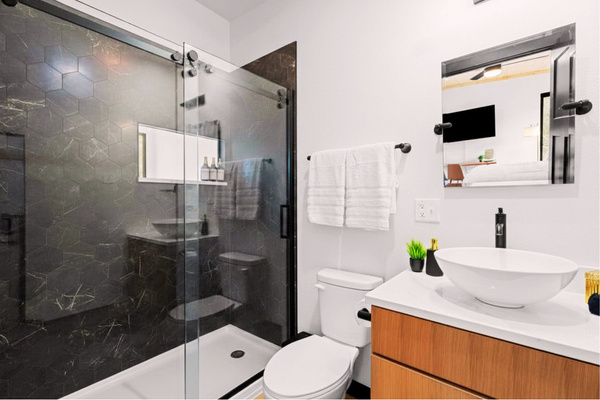 Never lose sight of the natural surroundings - even while showering in the clean, modern loft ensuite bathroom with a private view of the outdoors.