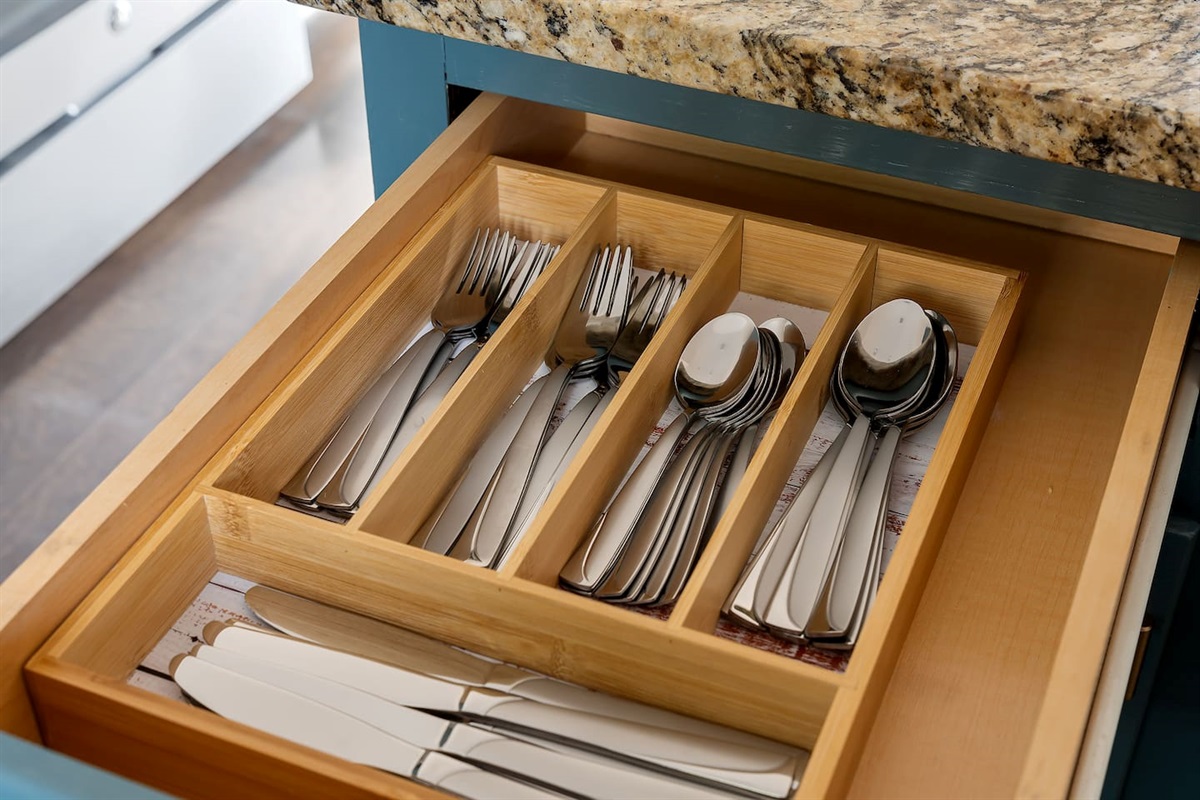 Ready to cook up a storm in this fully equipped kitchen, complete with a handy drawer filled with gleaming silverware.