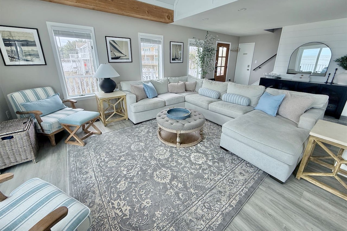 Relax in this spacious and inviting living area, perfect for unwinding in style. Featuring plush, comfortable seating, coastal-inspired decor, and ample space for the whole group, it is an ideal spot for luxury comfort.